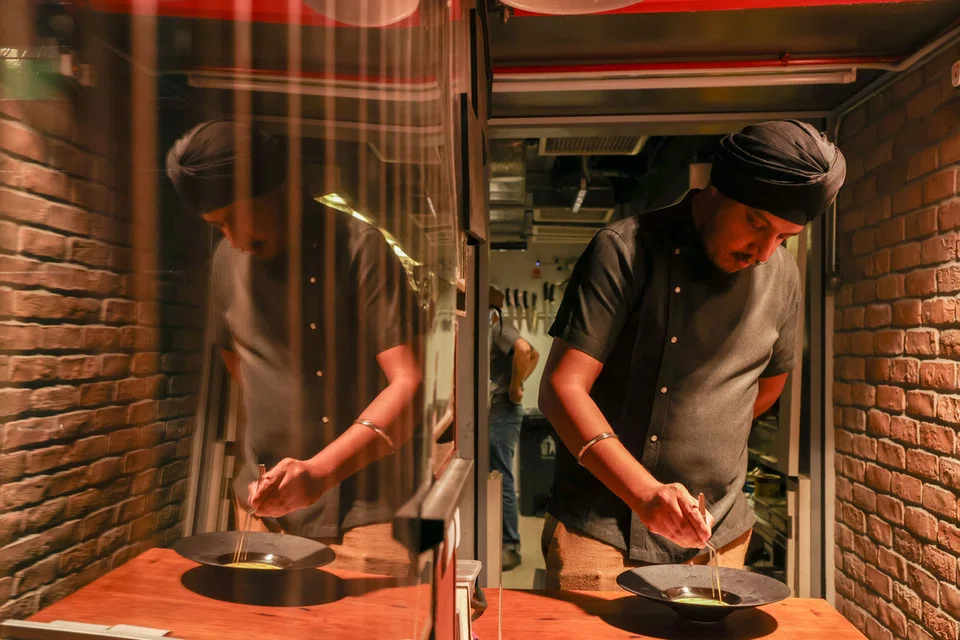 Chef Inderpal plating dishes before service at Meh’r.