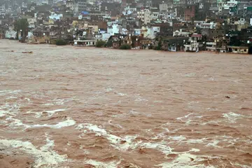 The Tawi River overflowing after heavy rain in Jammu, Indian Kashmir, on Aug 26.