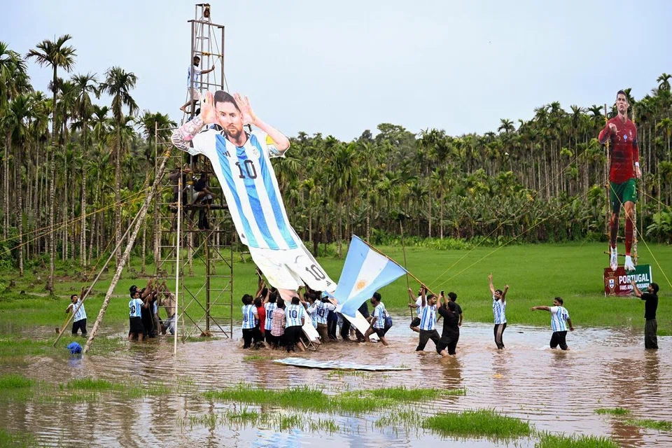 Supporters put up a cutout of Argentina's Lionel Messi next to one of Portugal's Cristiano Ronaldo in Kozhikode on June 9.