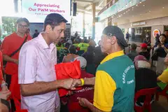 Minister of State for Manpower Dinesh Vasu Dash presents appreciation packs to workers covered under the Progressive Wage Model during the launch of NTUC’s “Appreciating Our PWM Workers” campaign