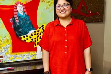 Sheena Bharathan with her painting that will feature at the exhibition.