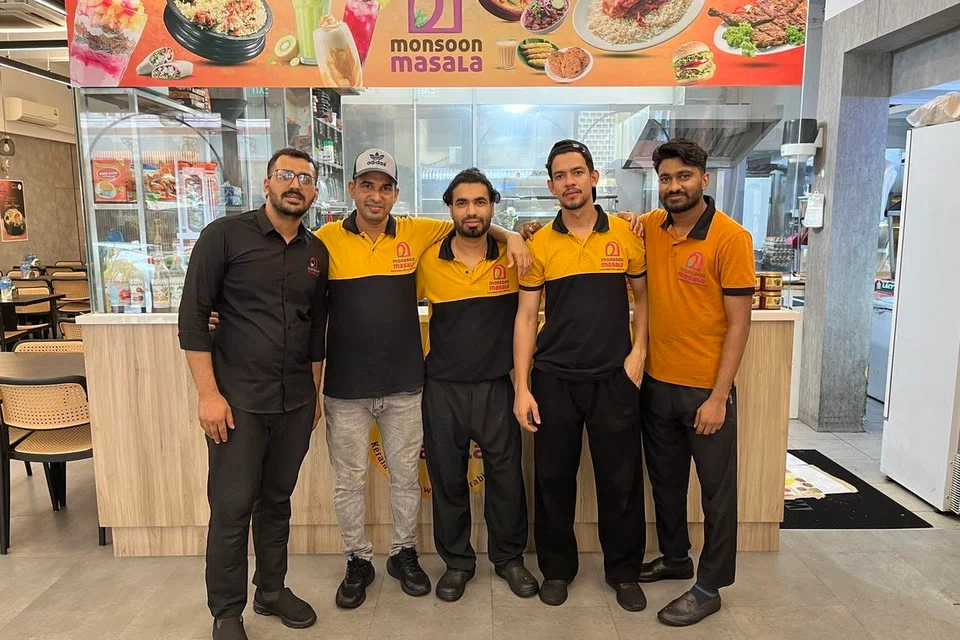 Mr Jasarath (in black) and his team at Monsoon Masala.
