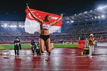 Shanti Pereira celebrating at the Paloma Mizuho Stadium in Nagoya after winning the 200m final.