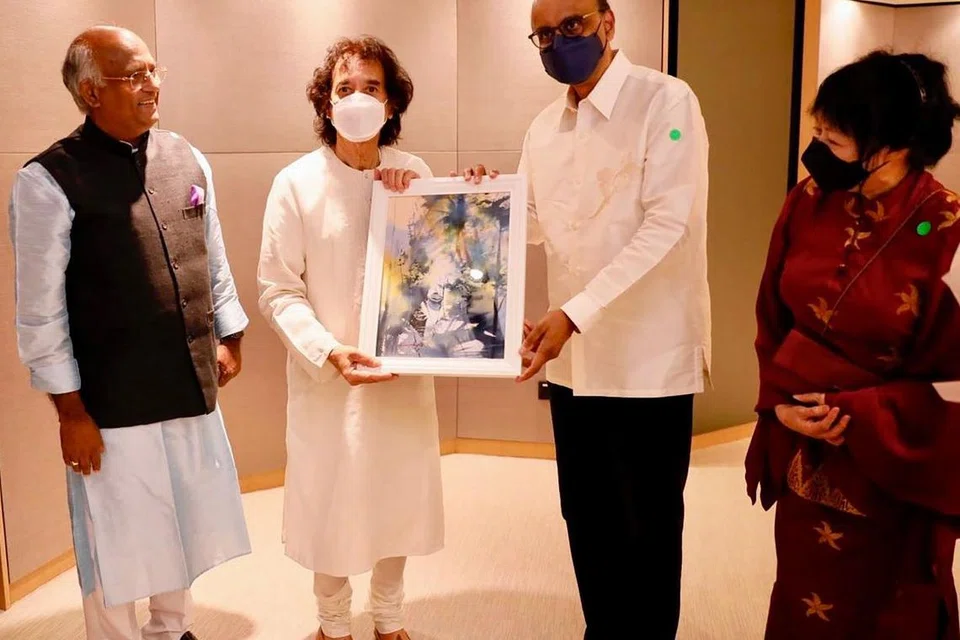 Then Deputy Prime Minister Tharman Shanmugaratnam presenting a token of appreciation to Zakir Hussain after the Triveni concert in 2022, as Sifas president K.V Rao and Mr Tharman’s wife Jane Ittogi look on.