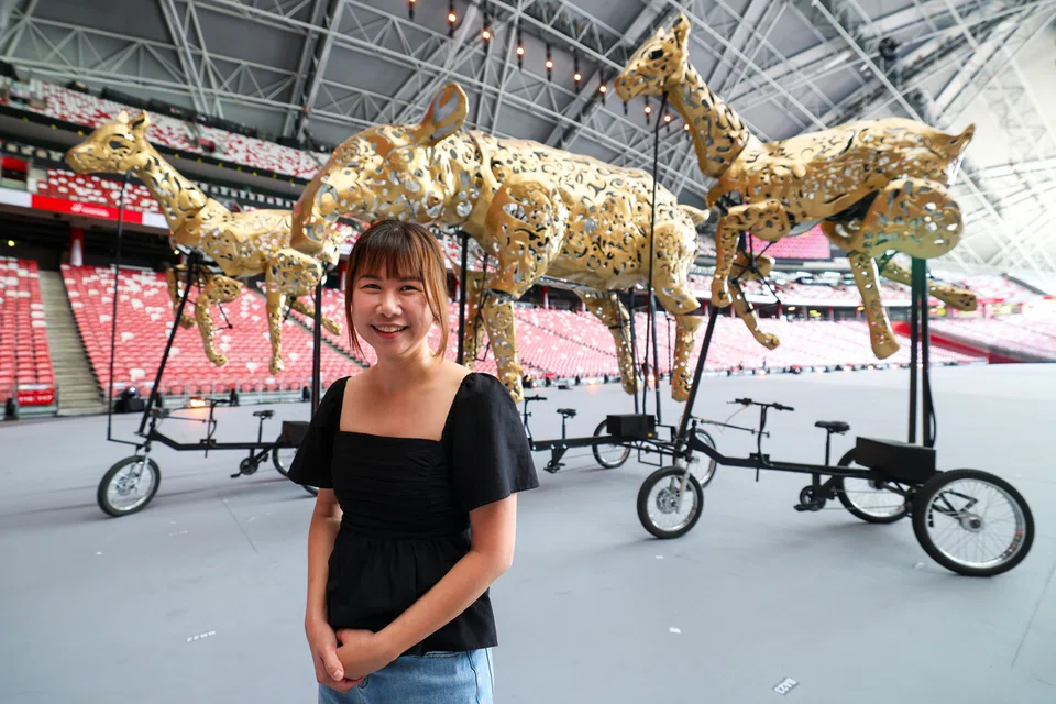 Designer Petrina Dawn Tan with the mechanically articulated oversized props inspired by traditional puppets and lanterns.