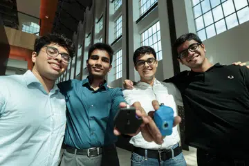(From left) Mr Yajat Gulati, Mr Sparsh, Mr Manas Bam and Mr Shrivardhan Goenka with their invention yaR, a pendant that taps on AI to help the visually impaired.