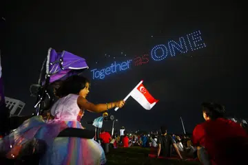 Spectators watching a drone display during the Central district celebrations in Bishan on Aug 10, 2024.