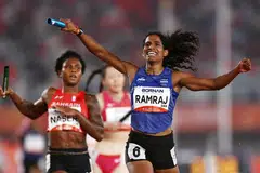 Gold medallist India's Vithya Ramraj celebrates as she crosses the finish line to win the Women's 4 x 400m Relay Final.