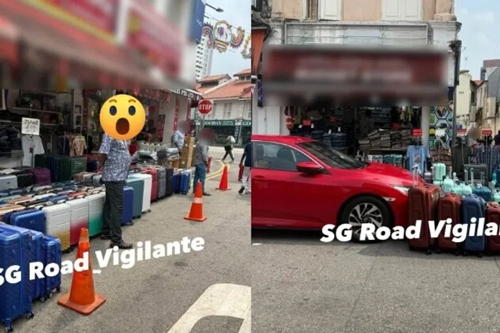 At least four lines of luggage can be seen on the road, stretching beyond the pedestrian pathway outside the shop and covering the double yellow line marker.