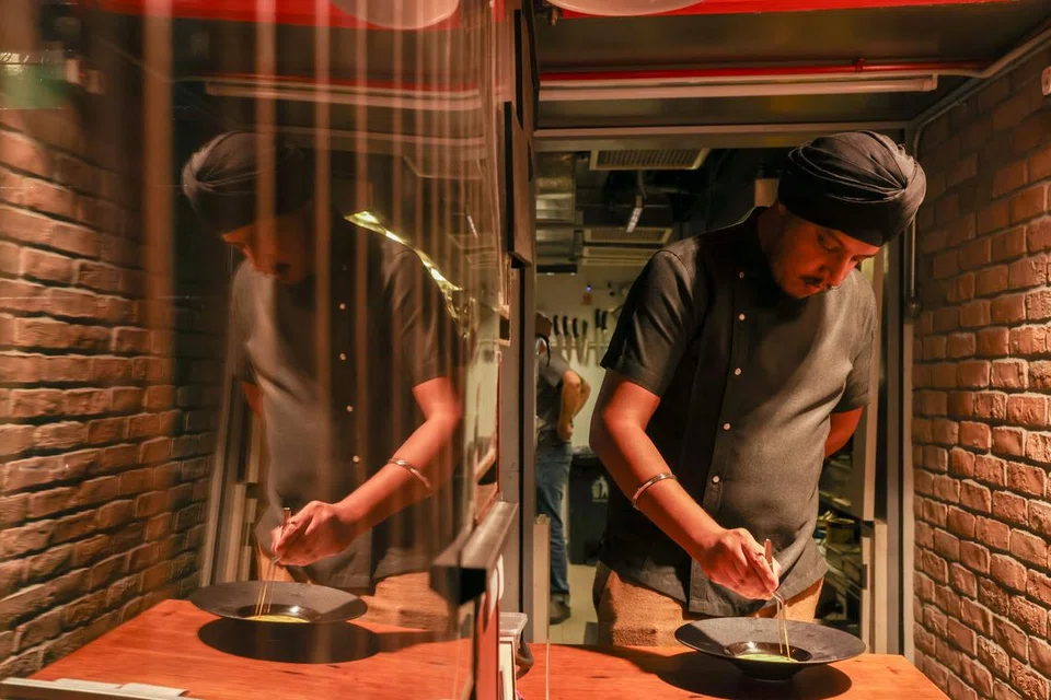 Chef Inderpal plating dishes before service at Meh’r. 