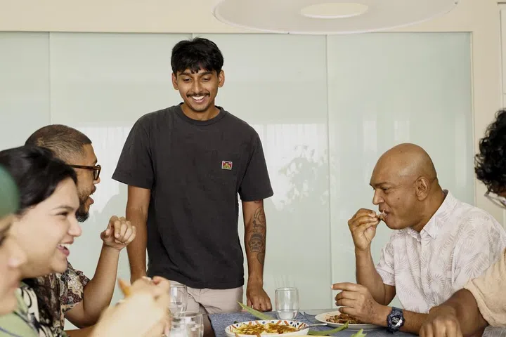 Azure Mohan with his friends, serving Nasi Lemak.