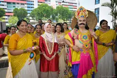 Guest of Honour, Minister of State for Health and Digital Development and Information, Rahayu Mahzam, being received at the festival by the Singapore Malayalee Association members and King Mahabali.
