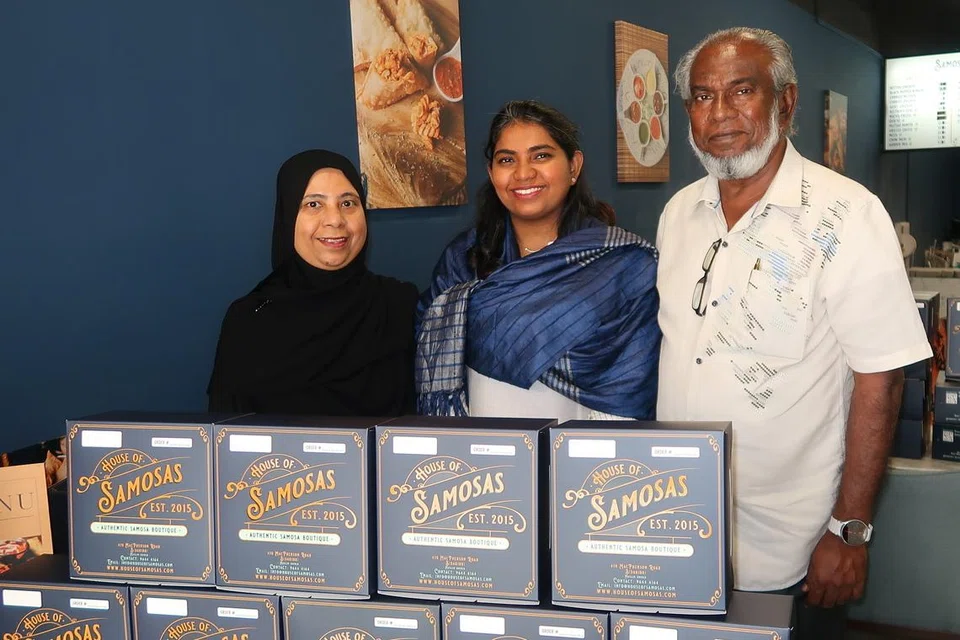 Ms Najeera Roseni (centre) with her mother, Mdm Noorul Ayn, and her father, Mr Haja Nizamuddeen, a lifelong Brazil football fan.