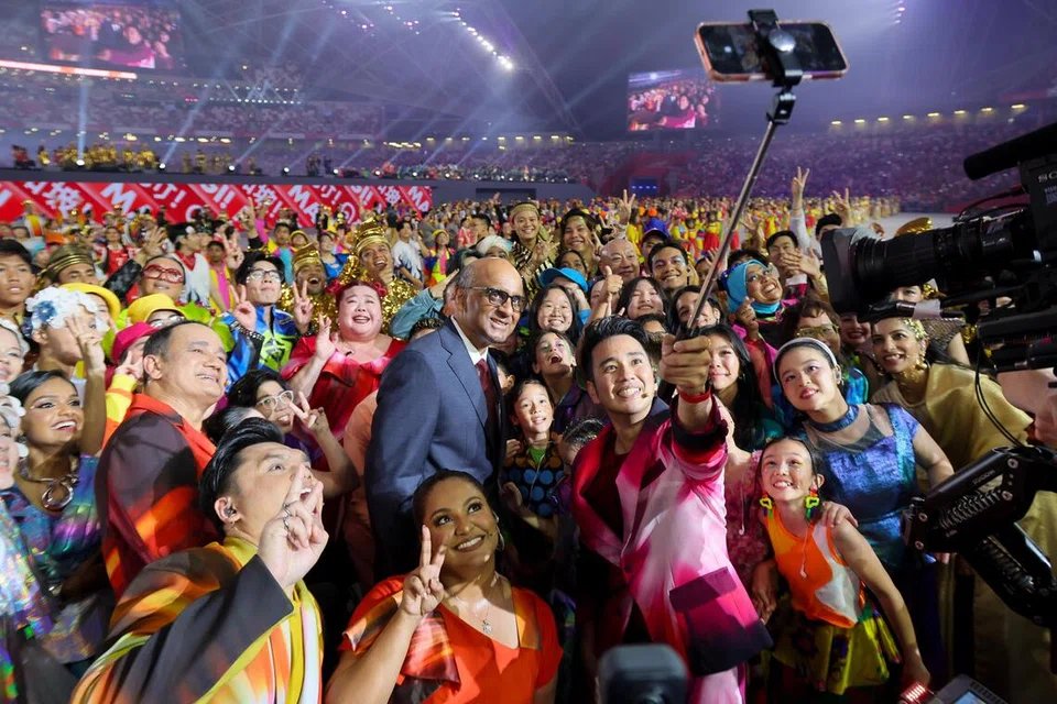 President Tharman Shanmugaratnam poses for a selfie with performers after the finale of the NDP 2026 at the National Stadium on Aug 9, 2026.