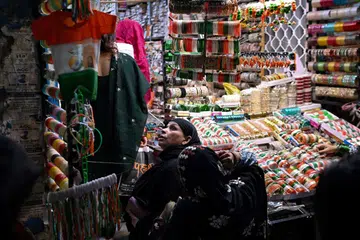 A woman looks at shirts in the colours of India's national flag, displayed at a market in the old quarters of Delhi on Aug 11, ahead of the country's Independence Day celebrations.
