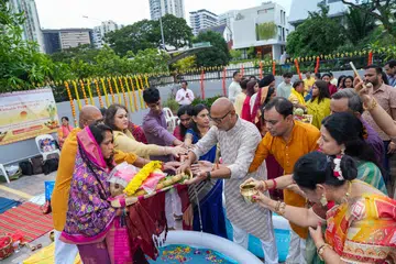 Devotees make their offerings (above) as a vrati (left) performs the rituals with deep devotion.