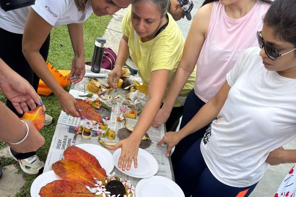 Participants using the collected twigs and leaves from the trail to make symbolic Mother’s Day collages.