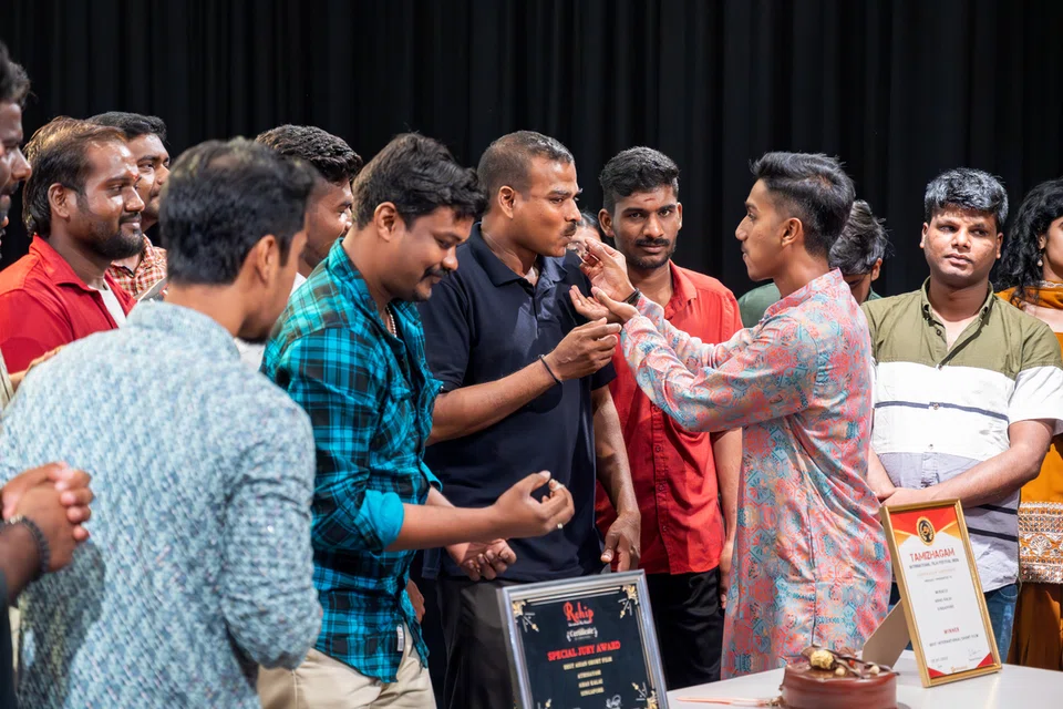 The film’s cast and crew invited the workers on stage to join a cake-cutting ceremony celebrating the film’s successful reception.