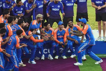 India’s captain Suryakumar Yadav (right) playfully pretends to hold the Asia Cup trophy as his team celebrates their victory in the final.