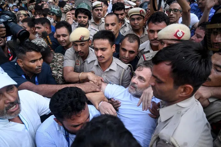 Security personnel detain India's Opposition Leader Rahul Gandhi as he stages a sit-in protest calling for Prime Minister Narendra Modi's resignation outside the latter's residence in New Delhi