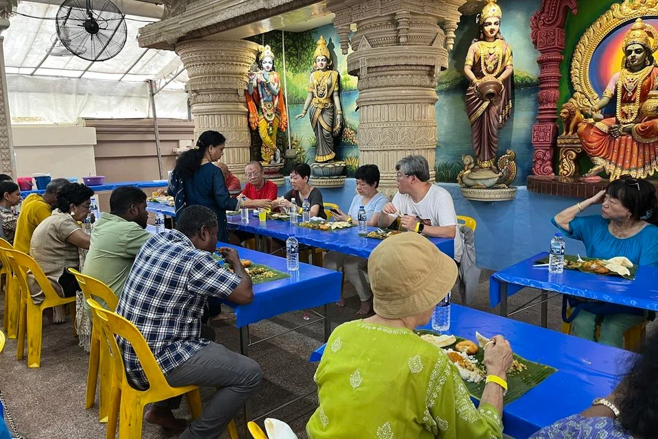 The Queenstown residents having a traditional banana leaf lunch at the Sri Krishnan Temple.
