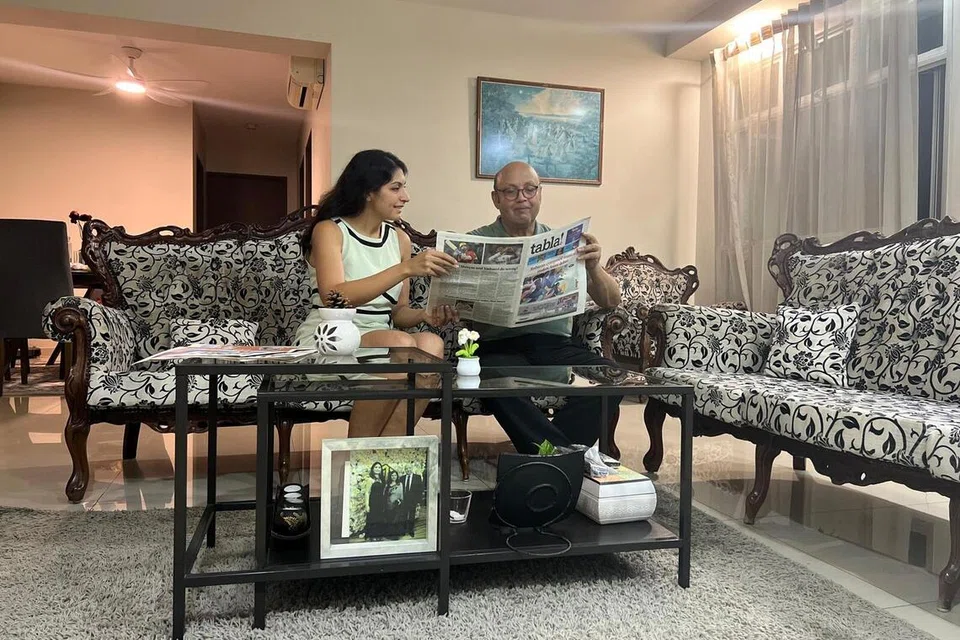 Ms Divika Jethmal and her father, Mr Nanik Jethmal, reading a copy of tabla! at their coffee table.