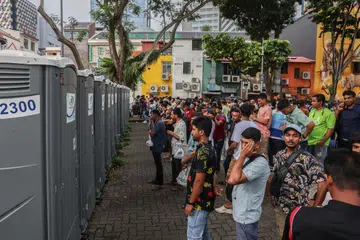 Long queues to use a row of portable toilets in Lembu Road on a busy Sunday in Little India.