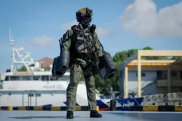 A Police Coast Guard Special Task Squadron officer wearing a jet-propelled manpack during a demonstration on May 14.