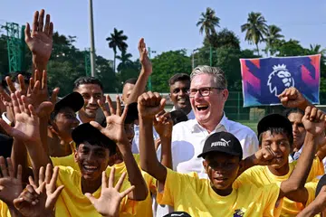 Britain’s Prime Minister Keir Starmer interacting with children during his visit to a Premier League youth training facility in Mumbai on Oct 8.