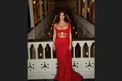 Kim Kardashian in one of the two red dresses she wore to the multi-day affair.