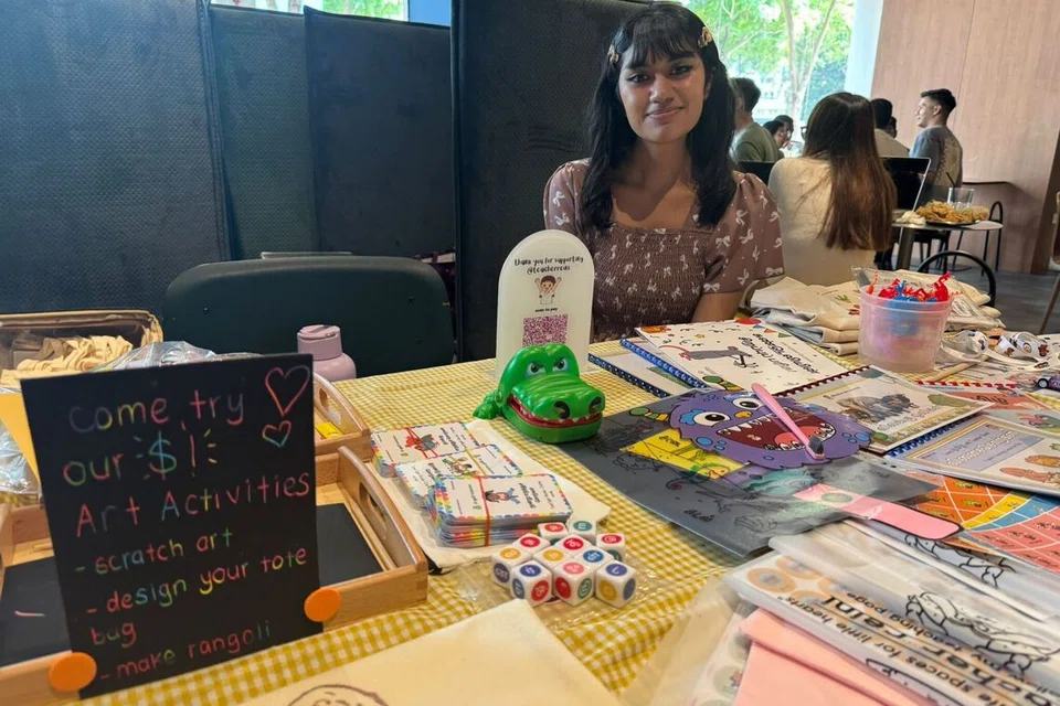 Ms Harreini Jeyaudin at her pop-up booth with play-based educational resources for local Tamil students.
