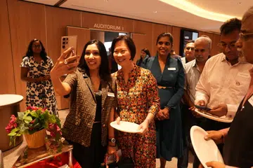 Verdus Technologies co-founder Kratti Agrawal (left) taking a selfie with Minister of State Gan Siow Huang, who interacted with guests after the dialogue.