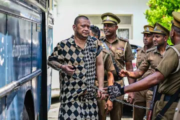 Prison guards escorting a foreign national in Kaduwela, a suburb of Colombo, Sri Lanka, on May 7.