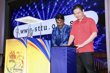 Prime Minister Lawrence Wong and Singapore Tamil Teachers' Union president Danapal Kumar launching Sanctuary of Power, which chronicles the organisation's 75-year journey.