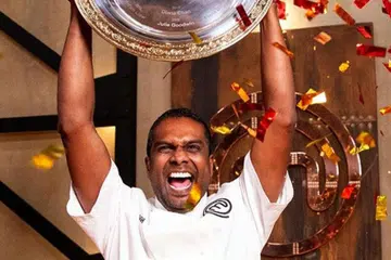 Sashi Cheliah lifts the MasterChef Australia 2018 trophy.