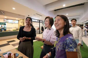 Ms Sohana Khatun explaining her “Wear Your Waste” initiative to Ms Grace Fu, Minister for Sustainability and the Environment, and Ms Goh Hanyan, Senior Parliamentary Secretary for Sustainability and the Environment.