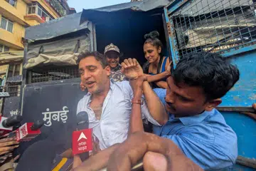 Bollywood actor Imran Khan is detained by security personnel during a protest by the Cockroach Janta Party (CJP) seeking the resignation of India's Chief Election Commissioner Gyanesh Kumar, in Mumbai, India, October 10, 2026.
