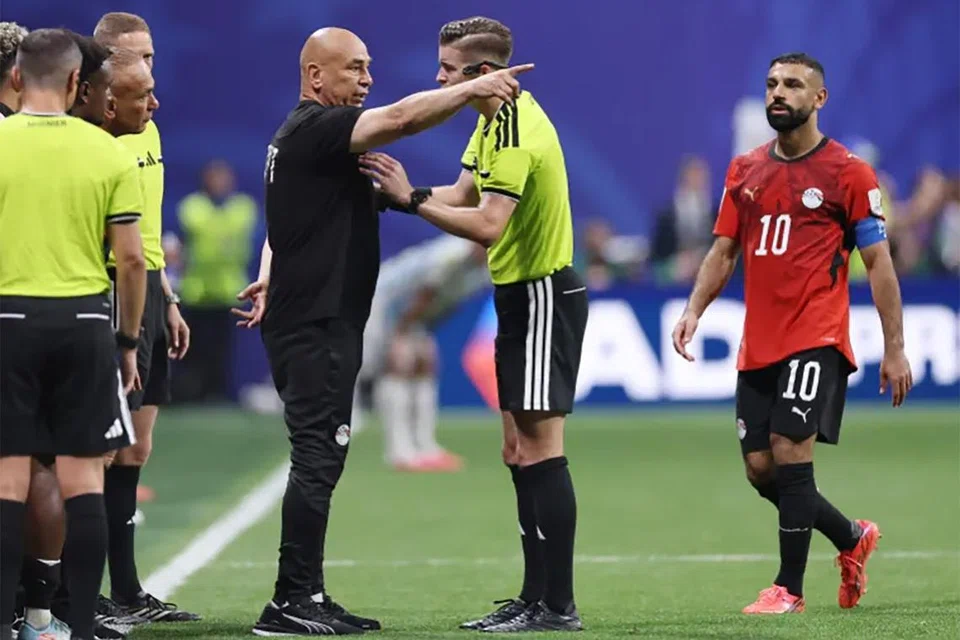 Egypt’s coach Hossam Hassan argues with referee Francois Letexier.