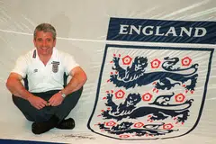 Then England's manager Kevin Keegan poses with with a giant England Shirt which will be used by the fans