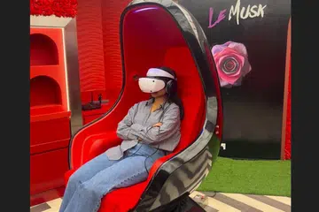 Journalist Reema Dudekula in a Positron Voyager pod, watching the movie. 