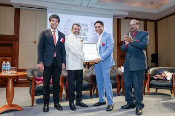 Mr Ravi Menon (second from left) receiving the IHFS Award from Minister of State Dinesh Vasu Dash. Others in the frame are MP Vikram Nair (left) and IHFS founder S.A. Nathan.