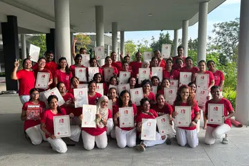 Yoga instructor Ms Neetu Somani and her students holding Singapore Book of Records’ certificates.