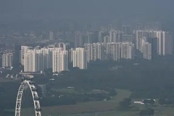 Hazy view of Singapore Flyer and housing, including condominiums in the eastern part of Singapore