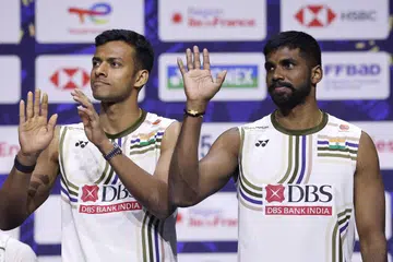 Satwiksairaj Rankireddy and Chirag Shetty celebrate their bronze win on the podium in Paris.