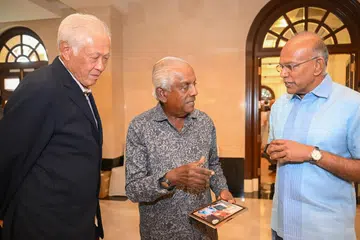 Senior MInister K. Shanmugam presented Professor S Jayakumar with a picture of the both of them, at the launch of the book ? Creating Three Unique Singapore Laws: With them is Dr Ng Eng Hen.