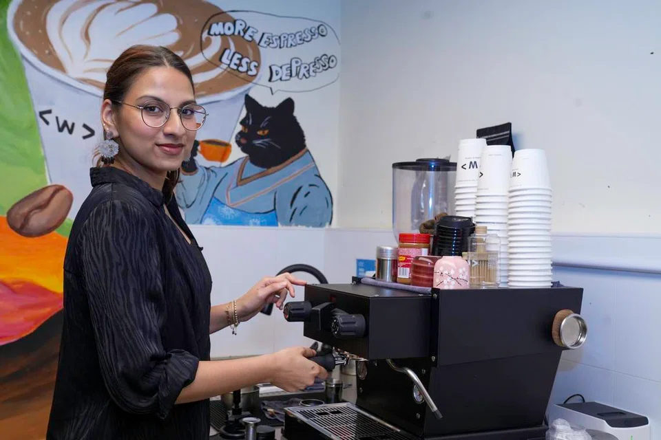 Uzma Mueez, 25, prepares a fresh beverage at her shop, Waterloo Coffee.