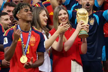 Princess Sofia of Spain lifts the trophy while Princess Leonor and Lamine Yamal of Spain watch at the award ceremony