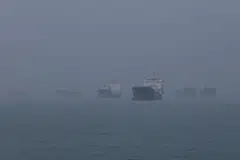Haze shrouds vessels anchored in the eastern waters of Singapore as smoke from regional wildfires reduces visibility across the island city-state in Singapore, October 16, 2026.