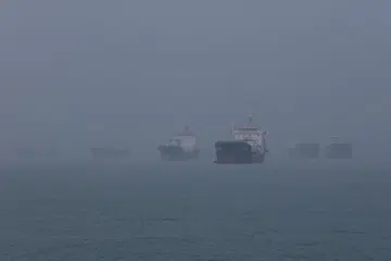 Haze shrouds vessels anchored in the eastern waters of Singapore as smoke from regional wildfires reduces visibility across the island city-state in Singapore, October 16, 2026.