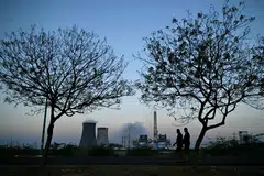 People walk near the Tuticorin Thermal Power Station at Thoothukudi in India's Tamil Nadu state on September 8, 2026. Tamil Nadu is among the state’s seeking more power allocations.